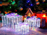 3 glowing Christmas gift boxes with bows 04567105