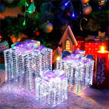 3 glowing Christmas gift boxes with bows 04567105