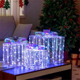 3 glowing Christmas gift boxes with bows 04567105